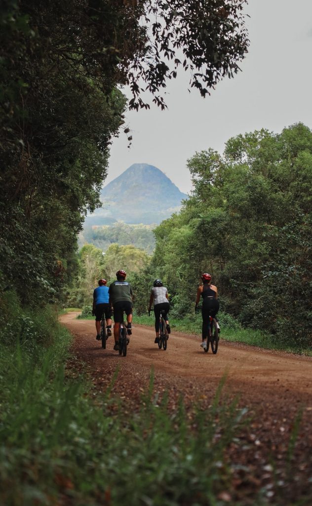Riders on a hinterland gravel road heading towards Mt Cooroora