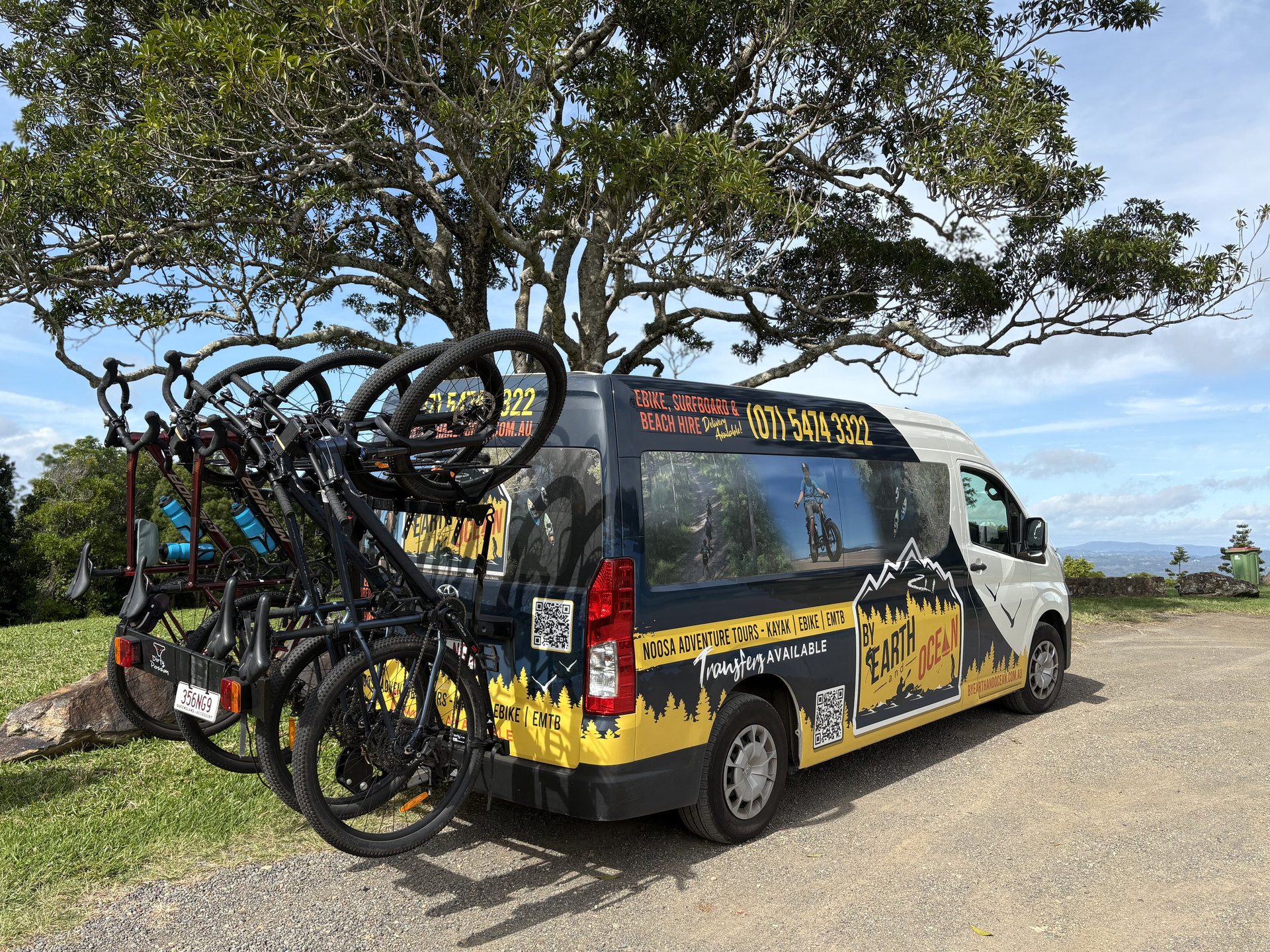 By Earth and Ocean transfer bus with mountain bikes loaded on the rear rack